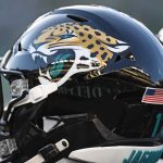 Football helmet with jaguar logo and USA flag.