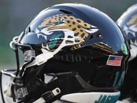 Football helmet with jaguar logo and USA flag.