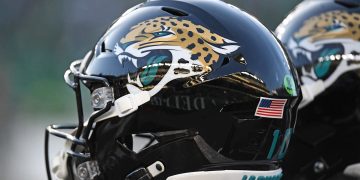 Football helmet with jaguar logo and USA flag.