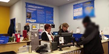 Customer service desk with staff and customer.