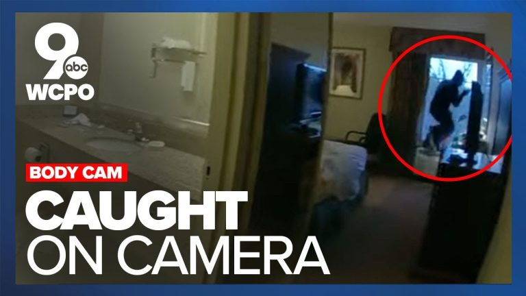 Body cam footage shows suspect jumping through window.