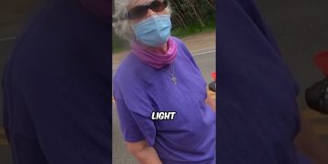 Person in mask and sunglasses on roadside