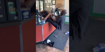 Person pulling another's hair in store setting.