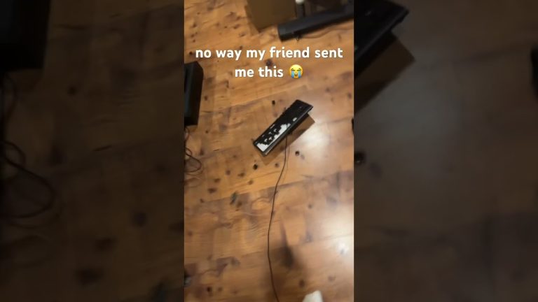 Broken keyboard on wooden floor with caption overlay.