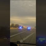 Police cars with flashing lights on highway