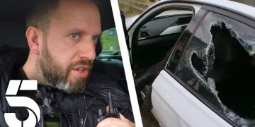 Police officer and car with shattered window