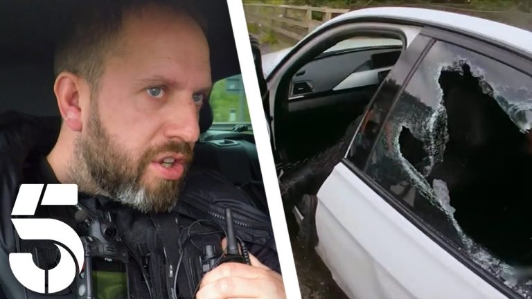 Police officer and car with shattered window