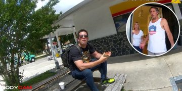 Man sitting outside gas station on wooden bench