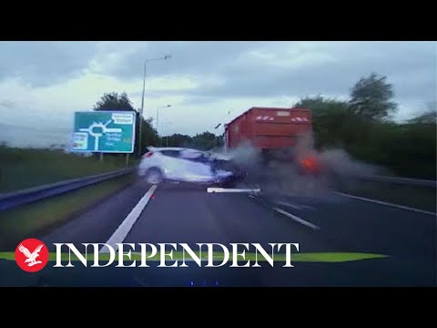 Car crash with truck on highway captured on dashcam.