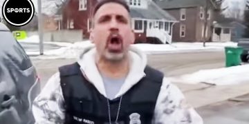 Man shouting outside in winter neighborhood.