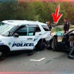 Police vehicle and car involved in accident scene.