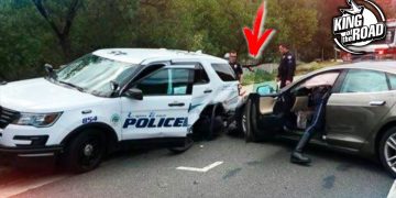 Police vehicle and car involved in accident scene.