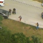 Police chase ends with suspect arrested on road.