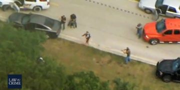 Police chase ends with suspect arrested on road.