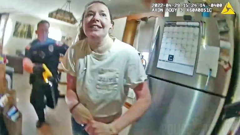 Woman in kitchen with police officer nearby