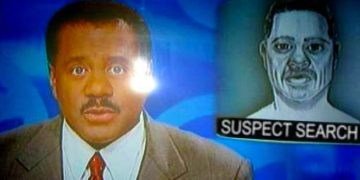 News anchor reporting suspect search on television broadcast.