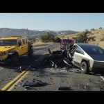 Car crash involving yellow and silver vehicles on road.