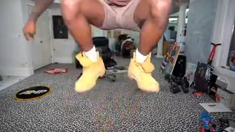 Person jumping indoors with boots on carpet