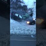 Car crashed in snowbank during winter.