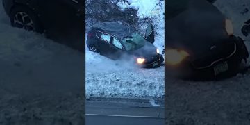 Car crashed in snowbank during winter.