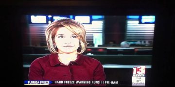 News anchor reports Florida freeze warning on TV.