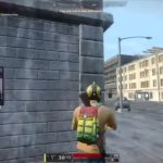 Streamer playing battle royale game on urban map