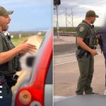 Police officer interacting with person near railroad crossing.