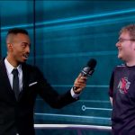 Interviewer speaks with esports player on stage.