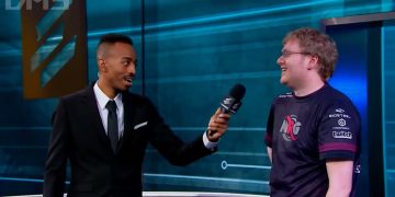 Interviewer speaks with esports player on stage.