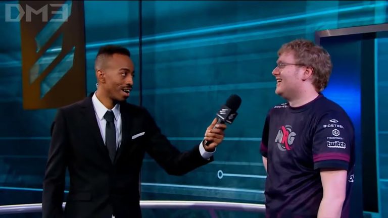 Interviewer speaks with esports player on stage.