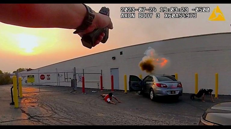 Police bodycam footage of vehicle explosion incident.