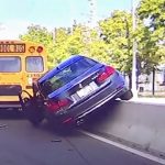 Car accident involving school bus and barrier.