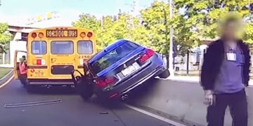 Car accident involving school bus and barrier.