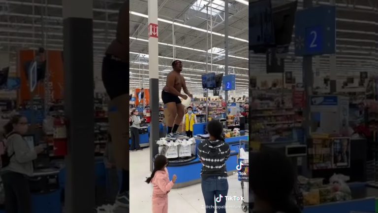 Person dancing on checkout stand in busy store.