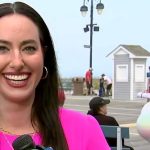 Smiling reporter with interesting background scene.