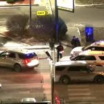 Police cars at snowy intersection at night