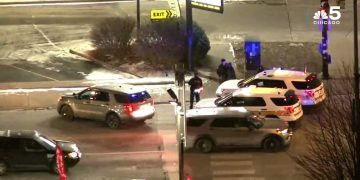 Police cars at snowy intersection at night