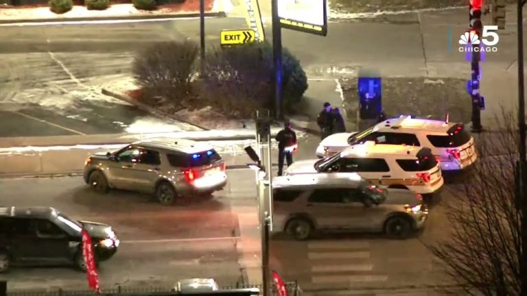 Police cars at snowy intersection at night