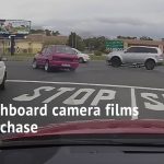 Dashcam captures intersection car chase scene.