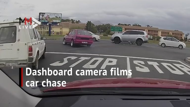 Dashcam captures intersection car chase scene.