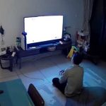 Person playing video game on TV in living room.