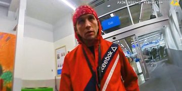 Person in red jacket at store entrance