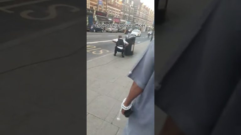 Street scene with police officer and pedestrians.