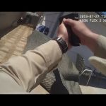 Body camera footage of police officer aiming weapon.