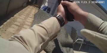 Body camera footage of police officer aiming weapon.