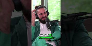 Man in green suit with headphones on podcast.