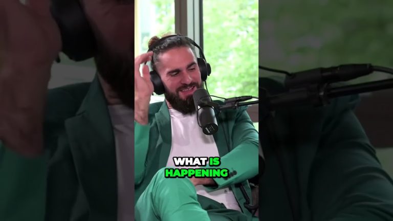 Man in green suit with headphones on podcast.