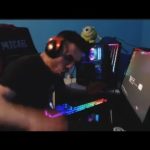 Gamer enthusiastically playing on RGB-lit computer setup