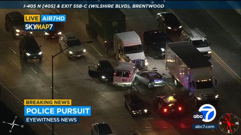 Police pursuit on highway with traffic jam, aerial view.