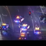 Police cars blocking intersection at night